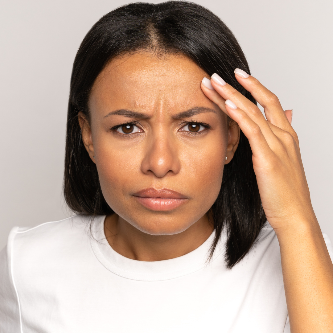 A woman with glowing skin tone showcasing the benefits of proper skincare for black skin.